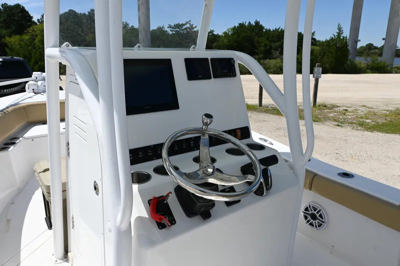 Slide: The Image of 2023 Clark Sound 24 boat console with steering wheel and electronic displays. - 6