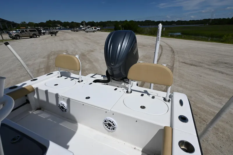 Slide: The Image of 2023 Clark Sound 24 boat with Yamaha outboard motor, parked on a sandy lot. - 8