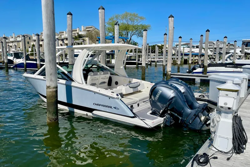Slide: The Image of 2023 Chaparral 280 OSX boat docked with Yamaha outboard engines. - 24