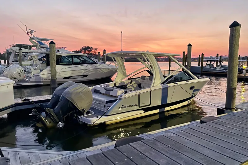 Slide: The Image of 2023 Chaparral 280 OSX boat docked at sunset, showcasing sleek design and modern features. - 26