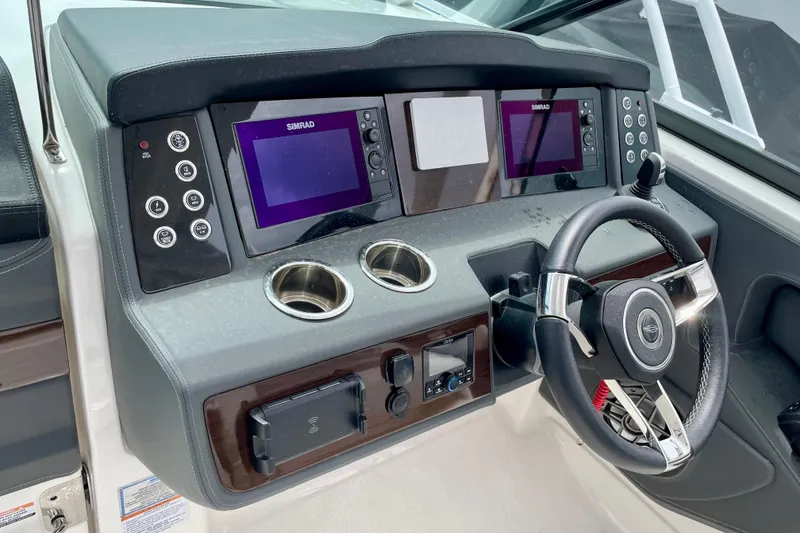 Slide: The Image of 2023 Chaparral 280 OSX helm with dual Simrad displays and modern steering wheel. - 30