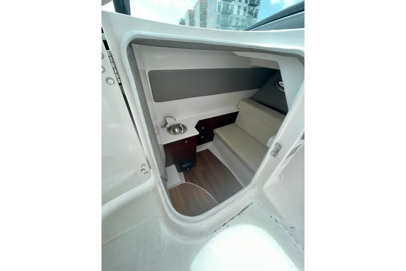 Slide: The Image of 2023 Chaparral 280 OSX cabin interior with seating and sink. - 31