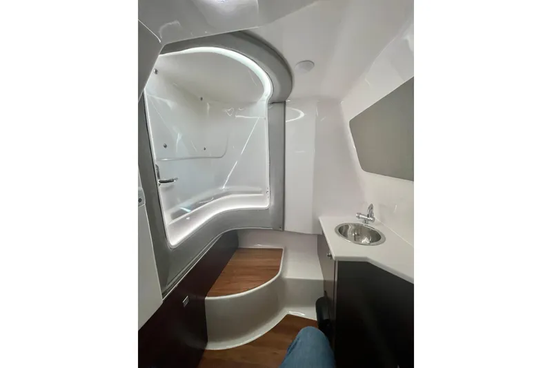 Slide: The Image of 2023 Chaparral 280 OSX boat interior with modern bathroom and sleek design. - 32