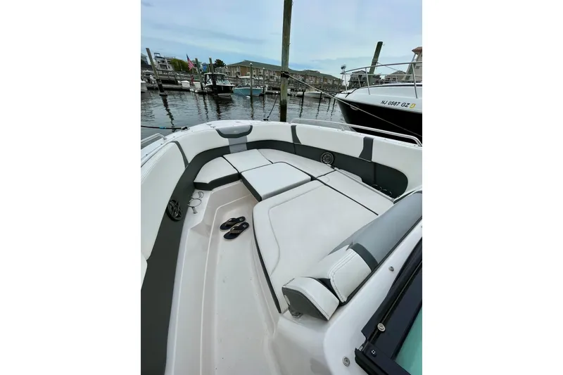 Slide: The Image of 2023 Chaparral 280 OSX boat interior with seating, docked at marina. - 35
