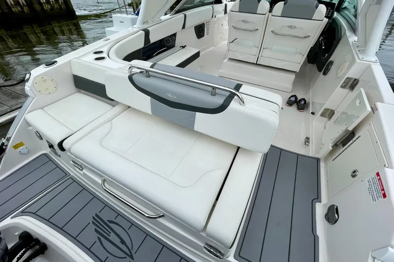 Slide: The Image of 2023 Chaparral 280 OSX boat interior with white seating and sleek design. - 38