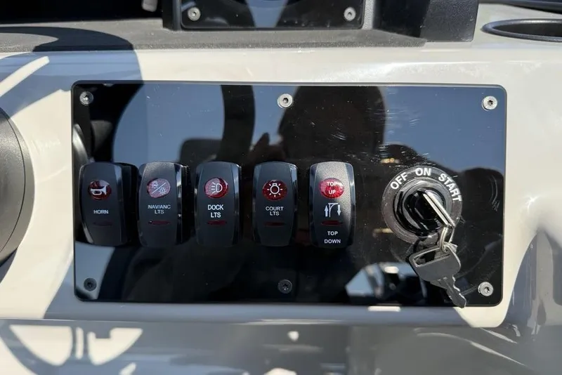Slide: The Image of Control panel of 2026 Premier 220 Sunscape RF with switches and ignition key. - 11