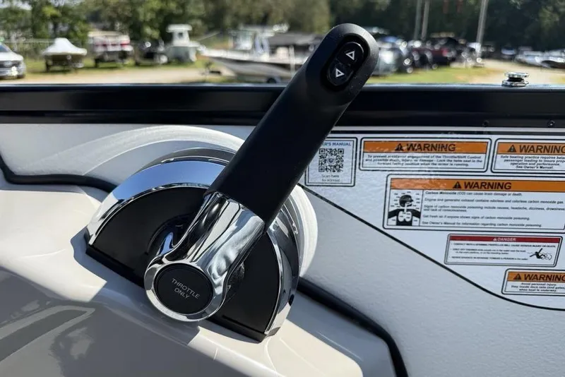 Slide: The Image of Throttle control of 2026 Premier 220 Sunscape RF boat with warning labels in background. - 20