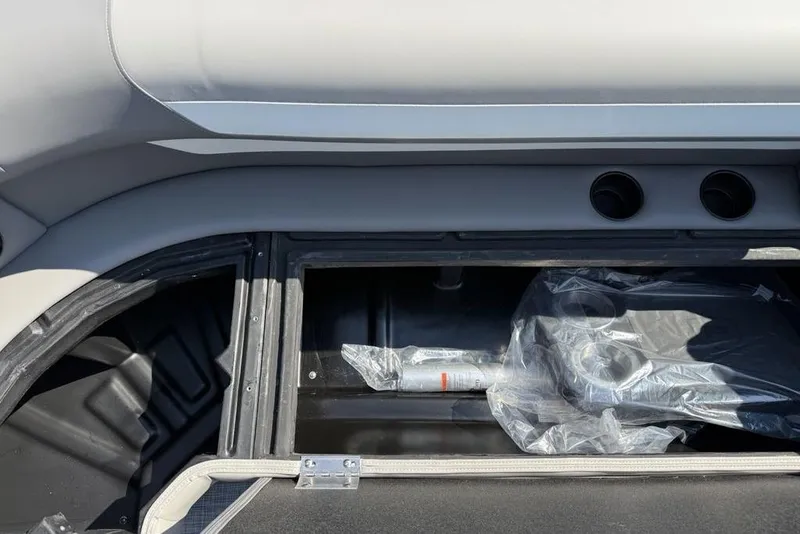 Slide: The Image of Storage compartment of 2026 Premier 220 Sunscape RF boat, featuring cup holders and accessories. - 5