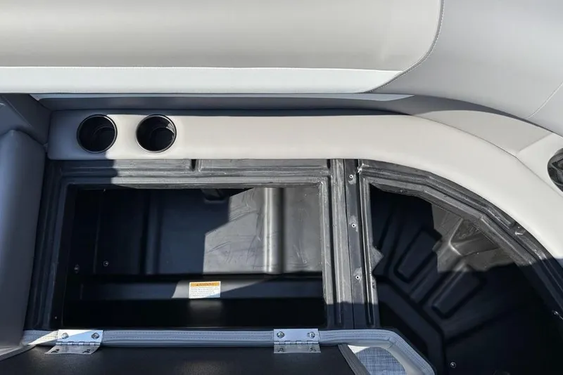 Slide: The Image of Interior storage compartment of 2026 Premier 220 Sunscape RF boat with cup holders. - 6