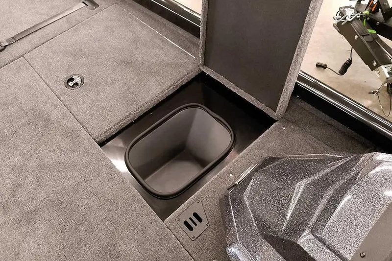 Slide: The Image of 2026 Ranger RT188P boat storage compartment with open hatch and carpeted interior. - 11