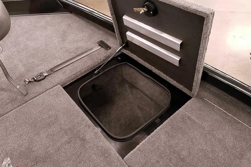 Slide: The Image of 2026 Ranger RT188P boat storage compartment with open lid and carpeted interior. - 12