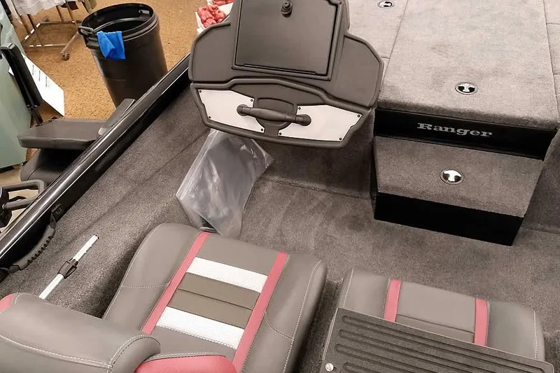 Slide: The Image of 2026 Ranger RT188P boat interior with gray and red seating, carpeted flooring, and storage compartments. - 17