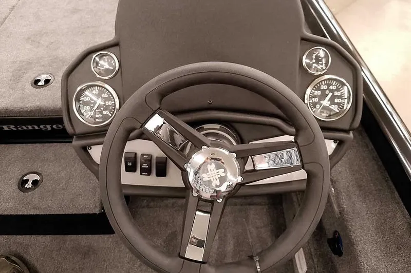 Slide: The Image of 2026 Ranger RT188P boat dashboard with steering wheel and gauges. - 21