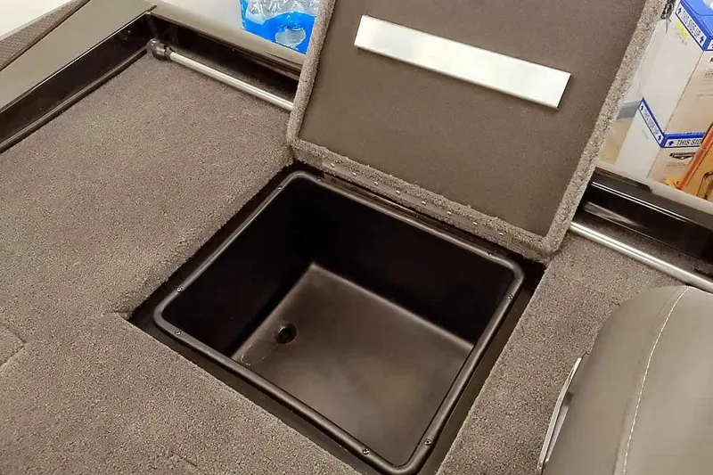 Slide: The Image of 2026 Ranger RT188P boat storage compartment with open lid, showcasing interior space. - 23