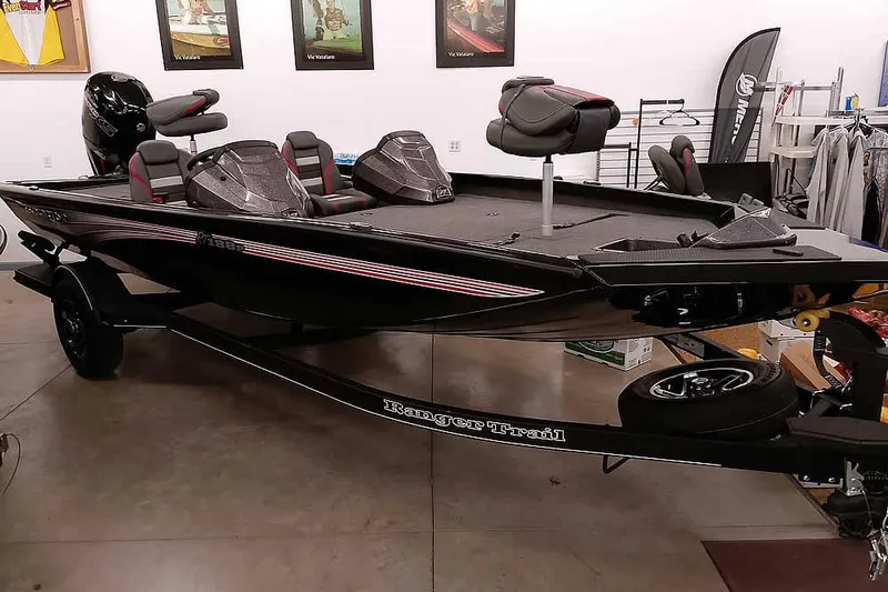 Slide: The Image of 2026 Ranger RT188P bass boat in showroom, featuring sleek black design and modern seating. - 28