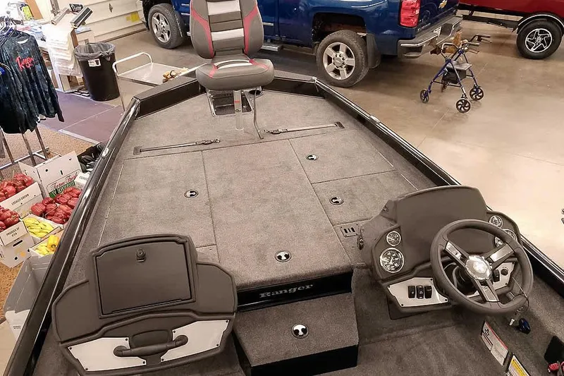 Slide: The Image of 2026 Ranger RT188P boat interior with steering wheel and seating in a showroom. - 7