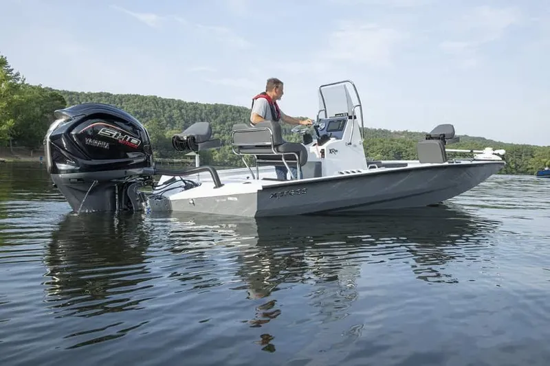 The Image of 2026 Xpress XR21 Bay boat on water, featuring sleek design and powerful engine. - 2
