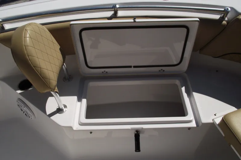 Slide: The Image of 2022 Sportsman Open 232 Center Console boat storage compartment with cushioned seating. - 10