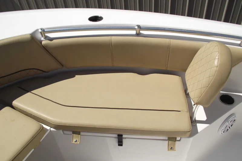 Slide: The Image of 2022 Sportsman Open 232 Center Console boat with tan cushioned seating. - 11