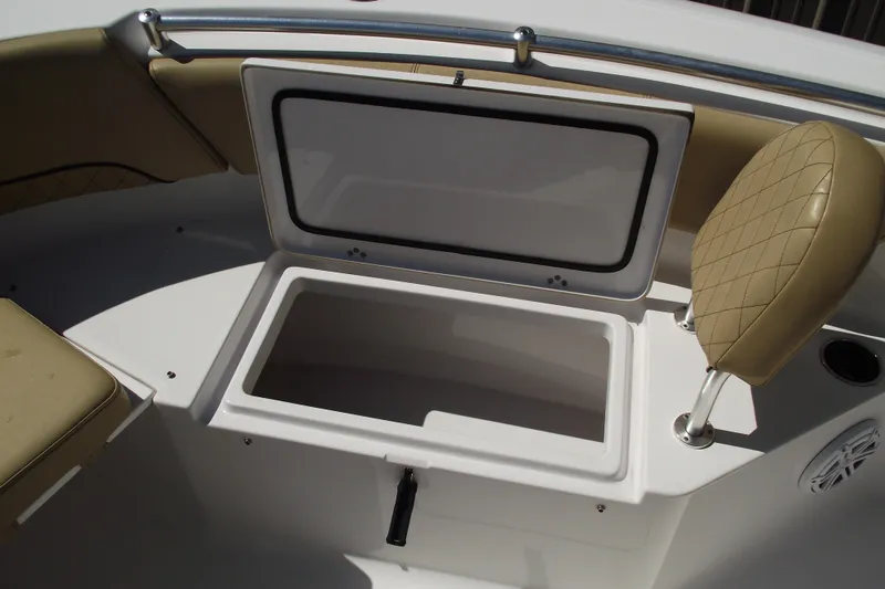 Slide: The Image of 2022 Sportsman Open 232 Center Console boat with open storage compartment and cushioned seating. - 13