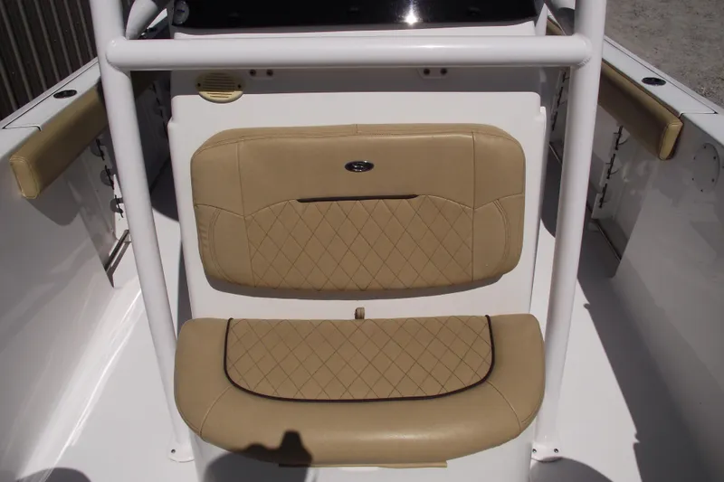 Slide: The Image of 2022 Sportsman Open 232 Center Console boat seating with tan upholstery and diamond stitching. - 14