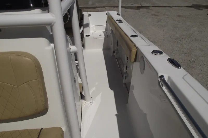 Slide: The Image of 2022 Sportsman Open 232 Center Console boat interior with tan seating and white deck. - 16