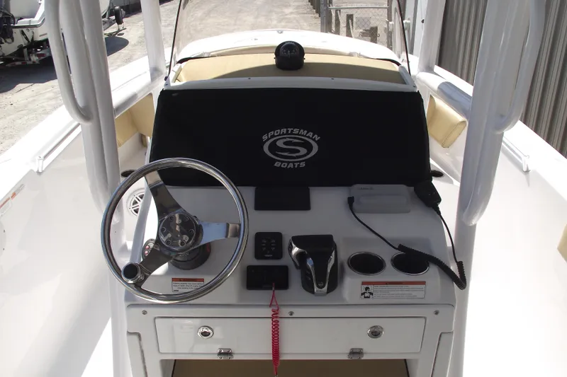 Slide: The Image of 2022 Sportsman Open 232 Center Console boat dashboard with steering wheel and controls. - 18