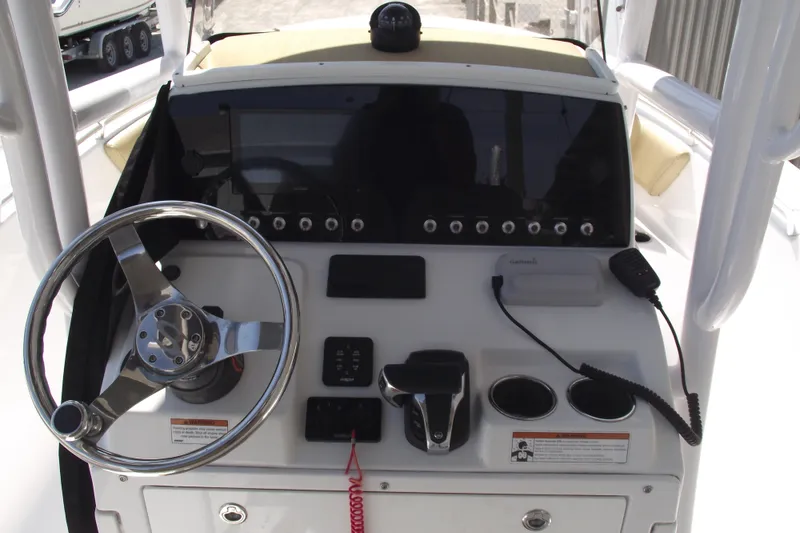 Slide: The Image of 2022 Sportsman Open 232 Center Console dashboard with steering wheel and controls. - 19