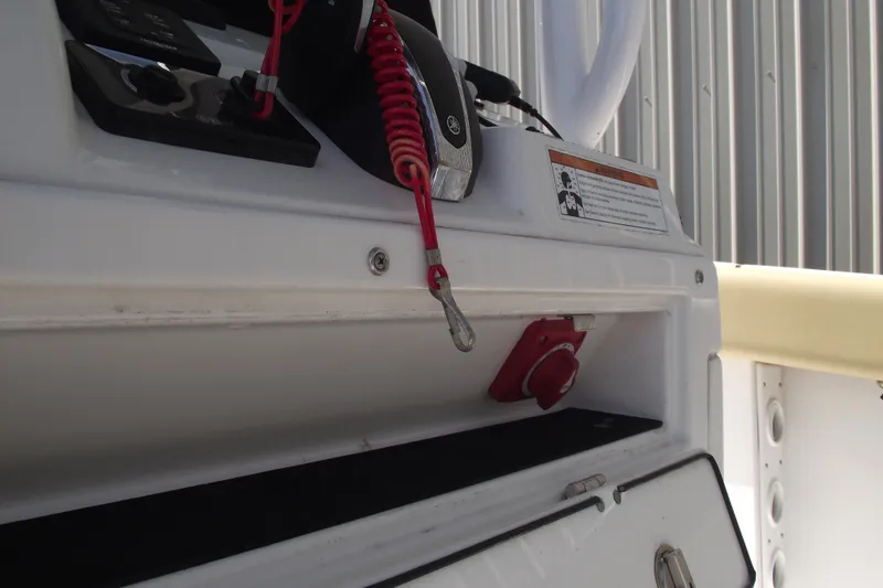 Slide: The Image of 2022 Sportsman Open 232 Center Console dashboard with safety lanyard and controls. - 20