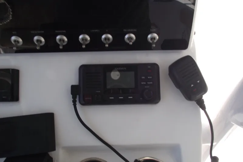 Slide: The Image of Control panel of 2022 Sportsman Open 232 Center Console with radio and switches. - 23