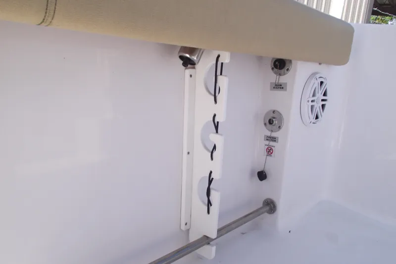 Slide: The Image of 2022 Sportsman Open 232 Center Console interior with rod holders and speaker. - 27