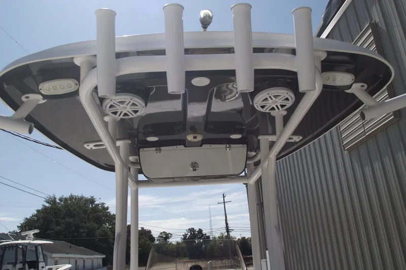 Slide: The Image of 2022 Sportsman Open 232 Center Console boat with T-top and rod holders. - 30