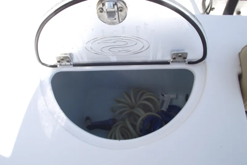 Slide: The Image of Open storage compartment on 2022 Sportsman Open 232 Center Console boat. - 32