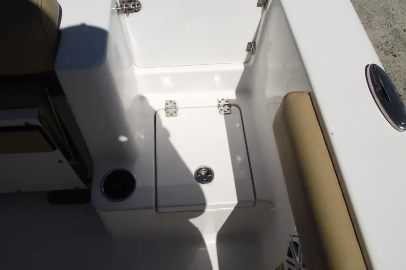 Slide: The Image of 2022 Sportsman Open 232 Center Console boat interior with storage compartment and cup holder. - 35