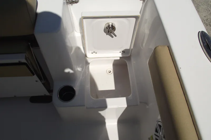 Slide: The Image of 2022 Sportsman Open 232 Center Console boat storage compartment and seating area. - 36