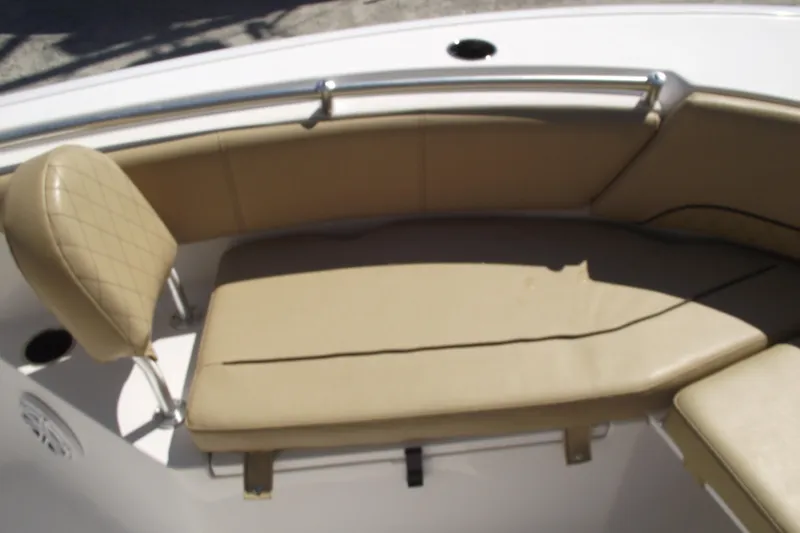 Slide: The Image of 2022 Sportsman Open 232 Center Console boat with tan seating and stainless steel railing. - 8