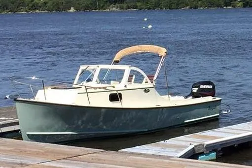 Slide: The Image of 2018 Seaway 21 Seafarer Cuddy boat docked on a serene lake. - 11