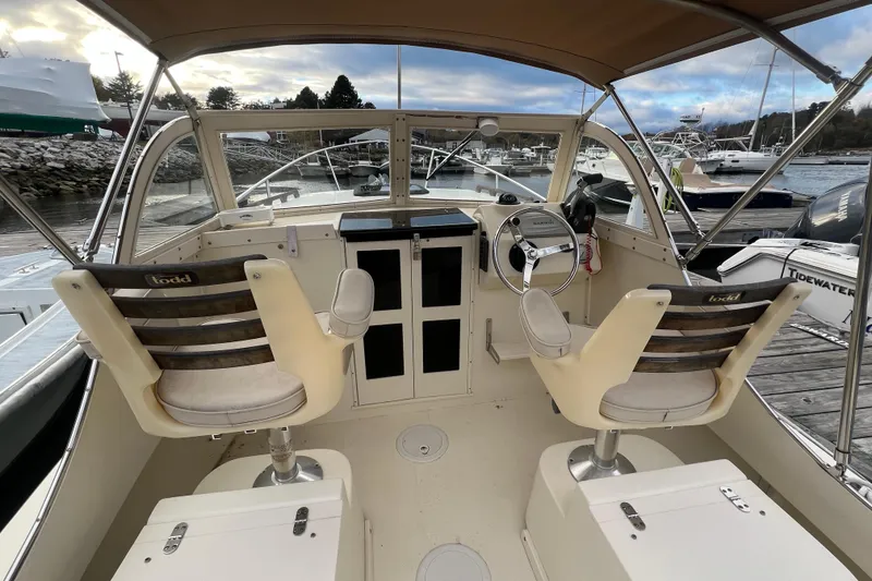 Slide: The Image of 2018 Seaway 21 Seafarer Cuddy boat interior with helm and seating at marina. - 3