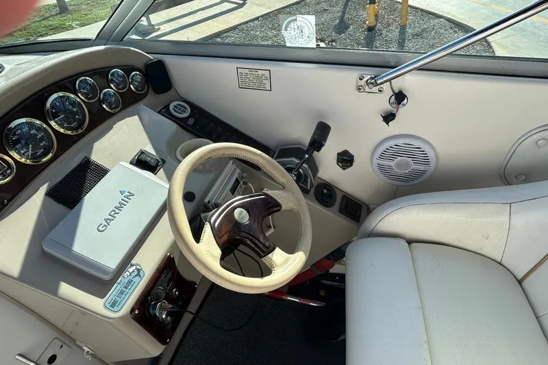 Slide: The Image of Cockpit of 2000 Rinker 270 Fiesta Vee with Garmin navigation system and gauges. - 11