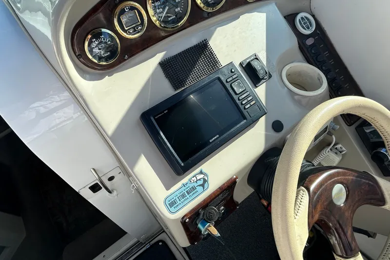 Slide: The Image of Dashboard of a 2000 Rinker 270 Fiesta Vee boat with Garmin GPS and gauges. - 13