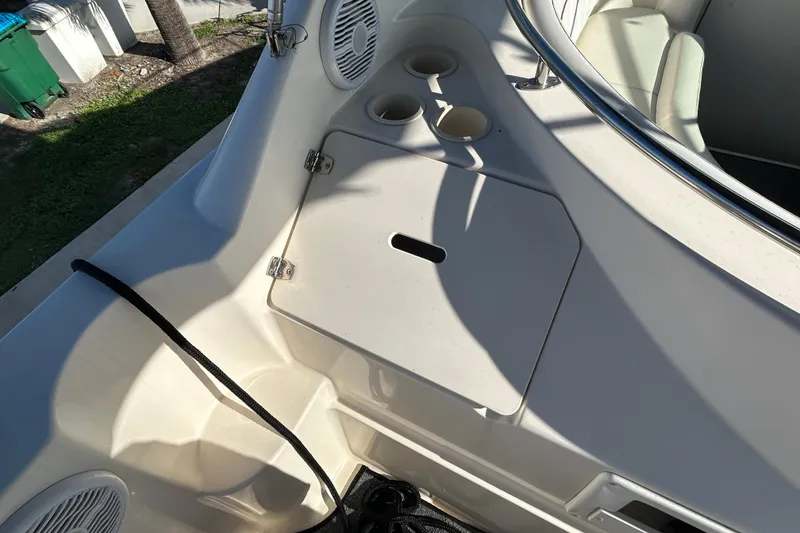 Slide: The Image of 2000 Rinker 270 Fiesta Vee boat interior with cup holders and storage compartment. - 26