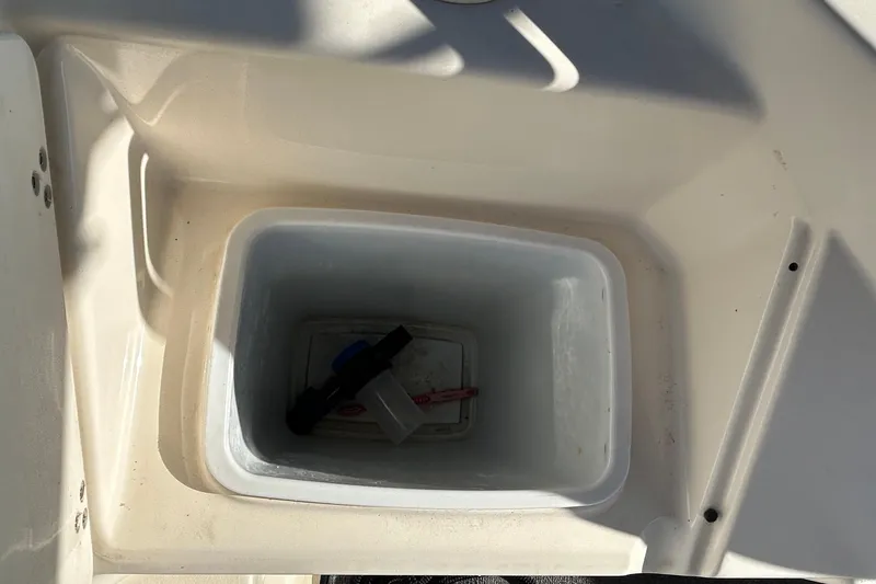 Slide: The Image of Storage compartment on a 2000 Rinker 270 Fiesta Vee boat, partially filled. - 27