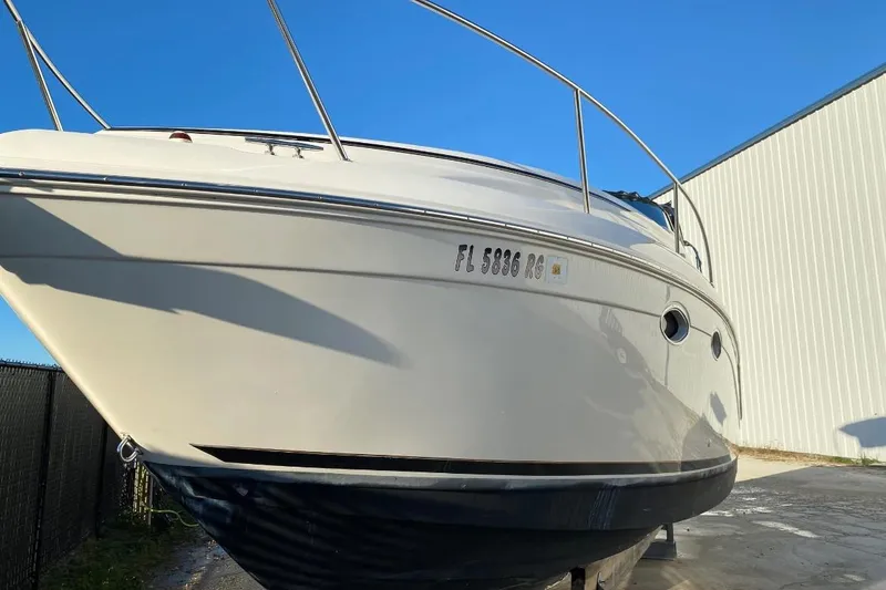 Slide: The Image of 2000 Rinker 270 Fiesta Vee boat on dry dock, sunny day, blue sky background. - 41