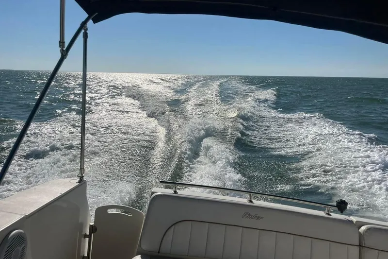 Slide: The Image of Rinker 270 Fiesta Vee boat cruising on open water, leaving a wake behind. - 5