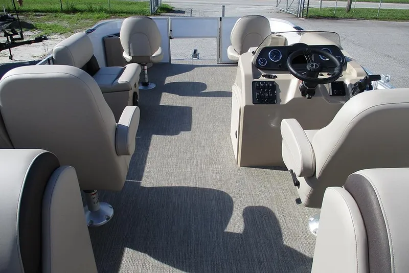 Slide: The Image of 2026 Bentley Pontoons 243 Fish CWT interior with beige seating and steering console. - 10