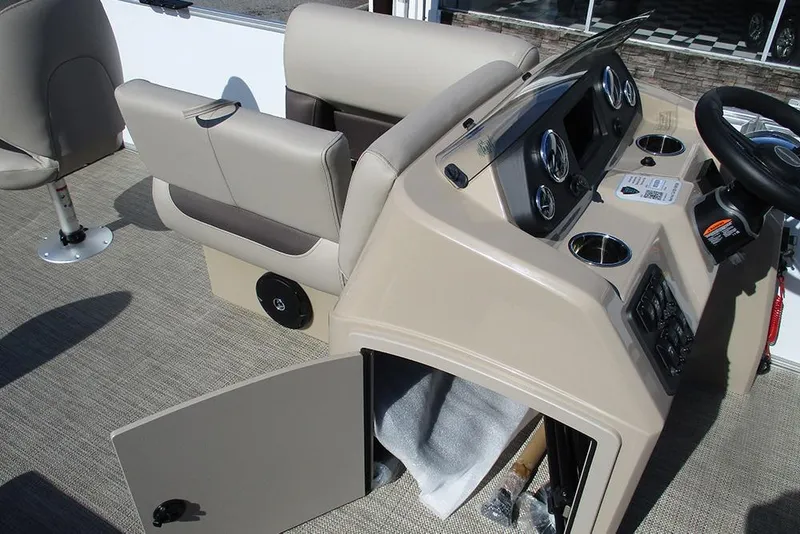 Slide: The Image of 2026 Bentley Pontoons 243 Fish CWT dashboard with beige seating and storage compartment open. - 18