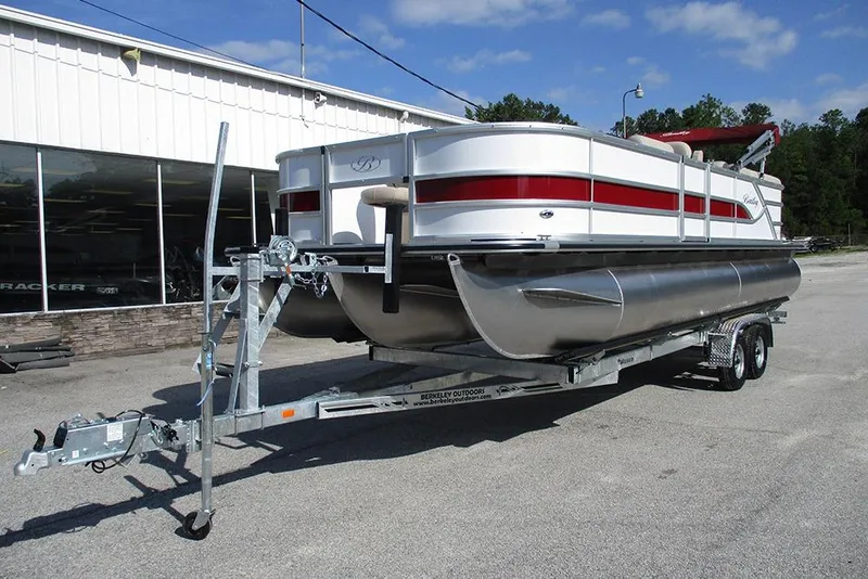 Slide: The Image of 2026 Bentley Pontoons 243 Fish CWT on trailer, parked outdoors near a building. - 3