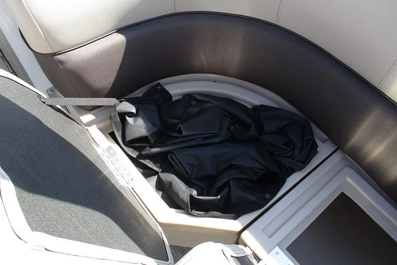 Slide: The Image of Storage compartment in 2026 Bentley Pontoons 243 Fish CWT boat, featuring black cover. - 34