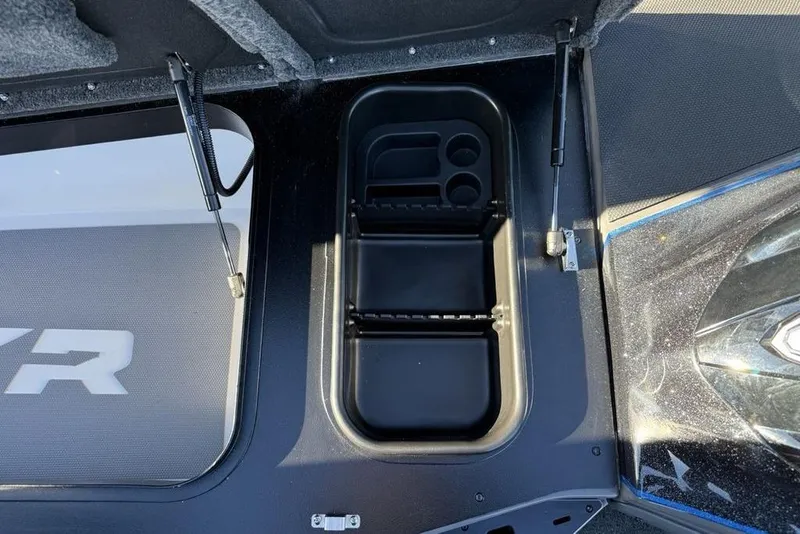 Slide: The Image of 2026 Skeeter FXR20 Apex boat storage compartment with organized tray and hydraulic lift. - 14