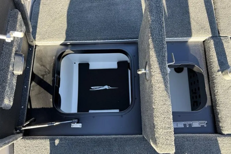 Slide: The Image of 2026 Skeeter FXR20 Apex boat storage compartments with open lids, showcasing interior design. - 20